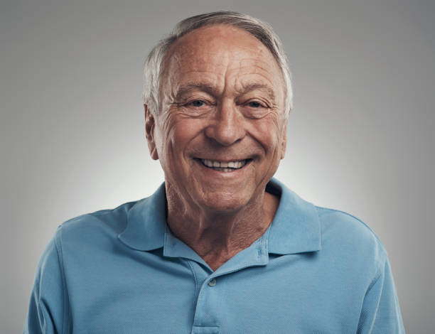 istock Shot of a man happily smiling at the camera in a studio against a grey background 1320142943