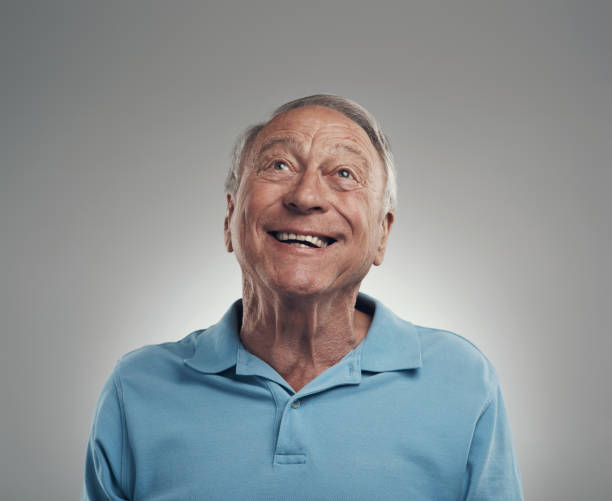 istock Shot of an elderly man smiling while gazing above himself in a studio against a grey background 1320142954