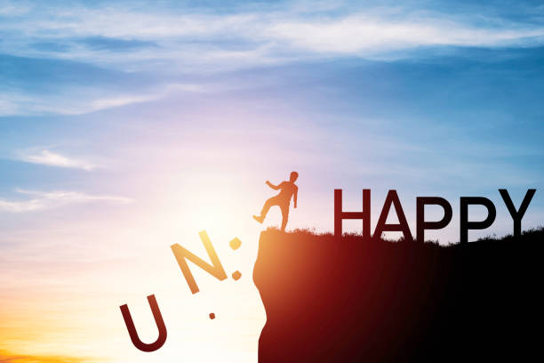 istock Silhouette man kick unhappy wording to happy from cliff and cloud blue sky , Personal Mindset concept. 1320143096