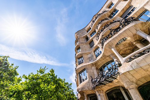 May 8, 2021 - Barcelona, Spain: Low angle front view of Casa Mila, also known as La Pedrera, designed by Antonio Gaudi located on Passeig De Gracia