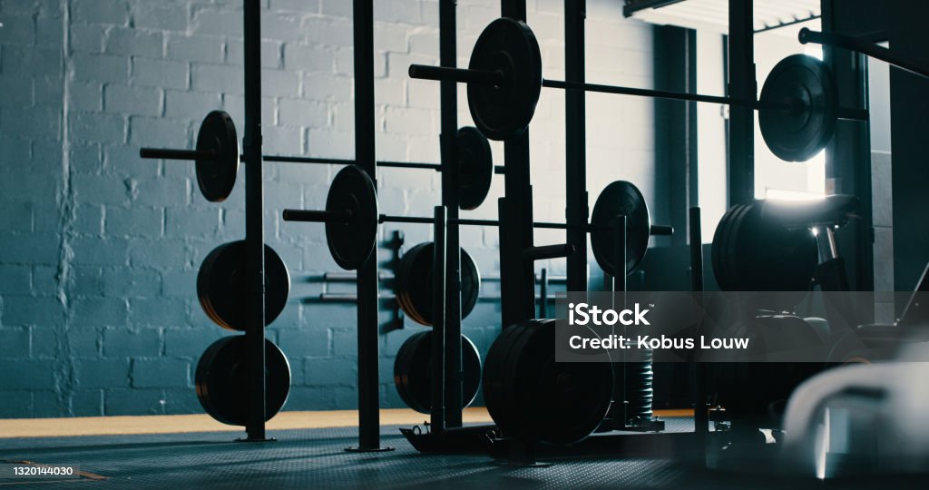 Still life shot of exercise equipment in a gym This is where the magic happens Gym Stock Photo