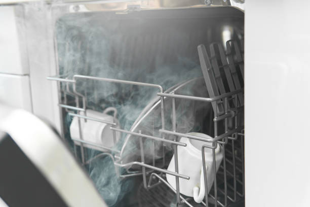 Dishwasher with a plates, cups and other dishware Closeup of dishwasher with a plates, cups and other dishware washing dishes photos stock pictures, royalty-free photos & images
