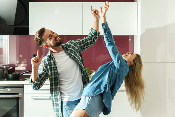 istock Couple dancing on the kitchen while cooking during sunny morning 1320146441