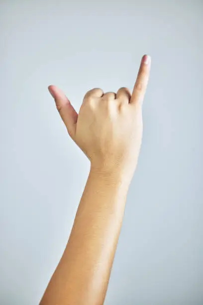 Photo of Cropped shot of a hand giving the hang ten signshaka