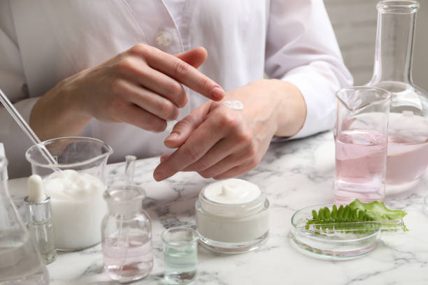 istock Scientist testing cosmetic product at white marble table in laboratory, closeup 1320146631