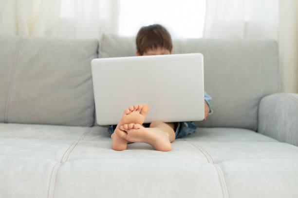 istock Kids and gadgets. Distance learning and virtual communication on isolation  quarantine in coronavirus. online chat. Boy and laptop at home. Lifestyle 1320146680