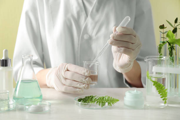 istock Scientist making cosmetic product at white table in laboratory, closeup 1320146742