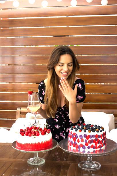 istock Beautiful young happy woman with cakes 1320146884