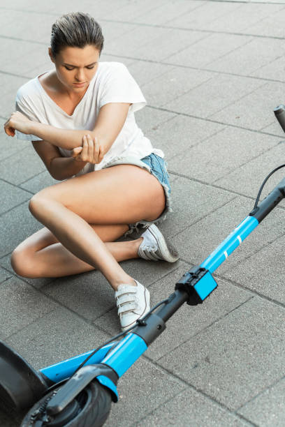 istock Young woman suffering from elbow pain after e-scooter riding accident 1320147176