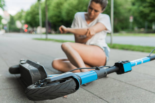 istock Young woman suffering from elbow pain after e-scooter riding accident 1320147203