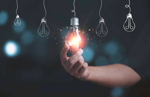 istock Businessman holding glowing lightbulb with light ray for creative thinking ideas and innovation concept. 1320147795