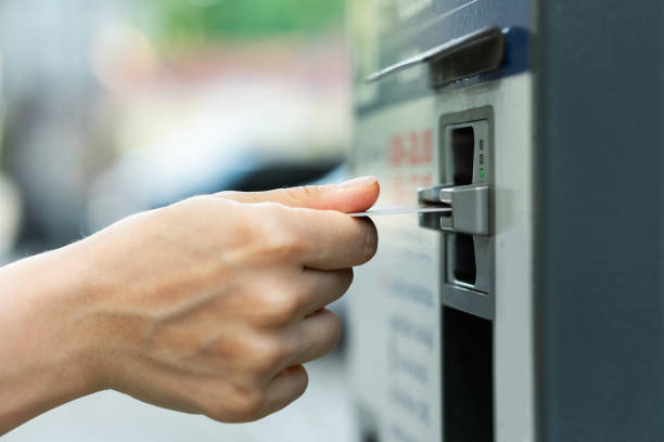 istock Female hand with a credit card and ticket vending machine 1320147970