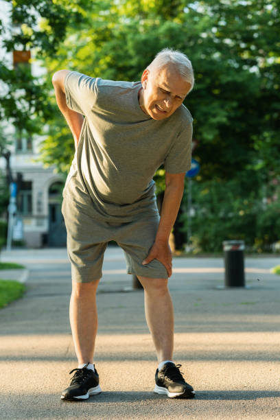 istock Elderly man suffering from pain in lower back during his jogging workout 1320148527