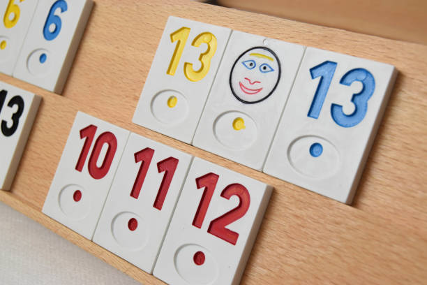 rummy game formations arranged on the board in selective focus. wooden board with sets of numbers. - rummy leisure games number color image imagens e fotografias de stock