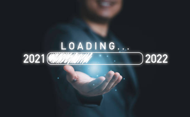 istock Businessman holding and giving virtual download bar with loading progress bar for New Year's Eve and changing year 2021 to 2022. 1320149184