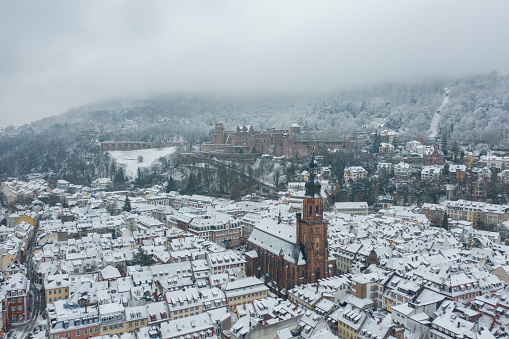 An aerial view of Heidelberg town and Neckar river in winter with snow from the castle in the Baden-Wurttemberg region of southwest Black Forest, Germany.