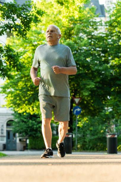 istock Elderly man during his jogging workout in a city park 1320149785