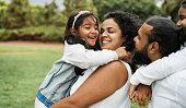 Happy indian family having fun outdoor - Hindu parents laughing with their children at city park - Love concept - Main focus on mother and daughter face