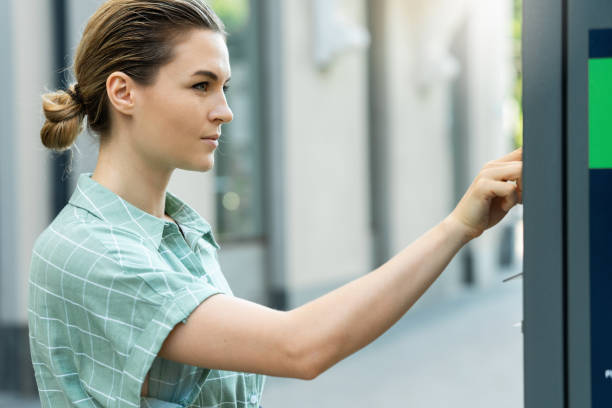 istock Attractive woman paying in the parking meter machine 1320149898