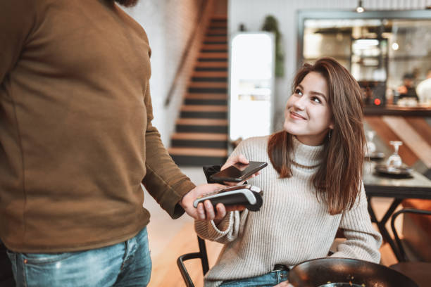 istock Smiling Female Happy To Use Mobile Payment In Restaurant 1320150032