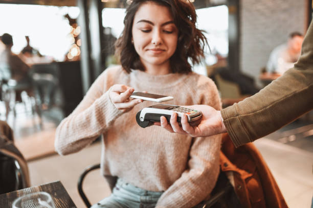 istock Female Paying In Restaurant By Mobile Phone 1320150062