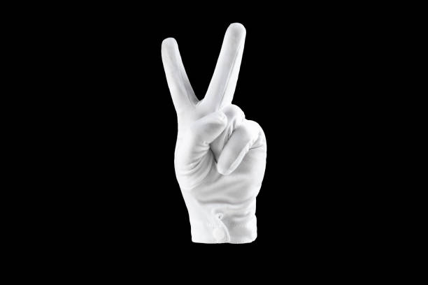 istock Human hand, hand in white glove isolated on black background, shows victory gesture with fingers. Human gesture concept. 1320152433