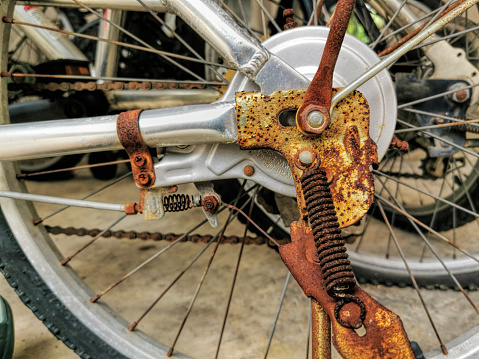 Close up of old rusty bicycle in public housing block, selective focus.