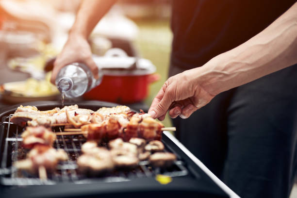 istock Preparing barbeque on a electrical modern grill outdoors. 1320156943