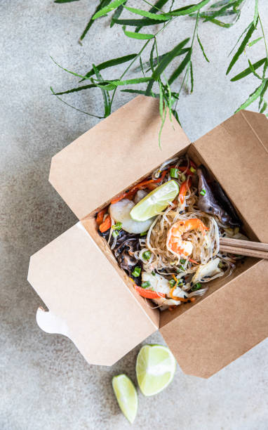 asian glass noodles with different types of seafood, vegetables and shiitake mushroom in disposable box. traditional asian takeaway food. top view. - prepared shrimp prawn seafood salad imagens e fotografias de stock