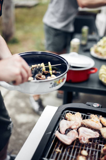 istock Preparing barbeque on a electrical modern grill outdoors. 1320156974
