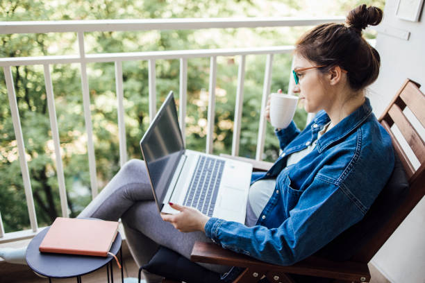 istock Young entrepreneur working and enjoying coffee on the balcony 1320157033