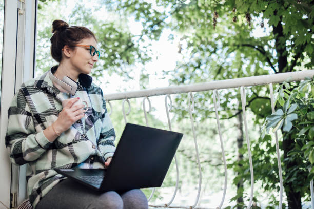 istock Young businesswoman enjoying fresh air while working on the balcony 1320157044
