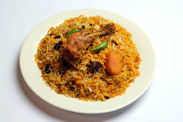 istock Isolated Delicious spicy chicken biryani in white plate on white background, Indian or Pakistani food. 1320157657