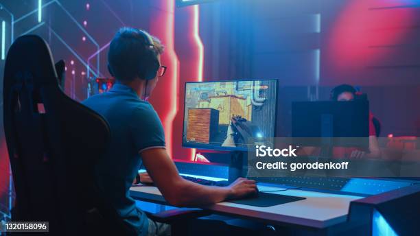 Professional Esports Gamer Plays Mockup 3d First Person Shooter Video Game His Personal Computer Cyber Gaming Tournament Championship Back View Shot Stock Photo - Download Image Now