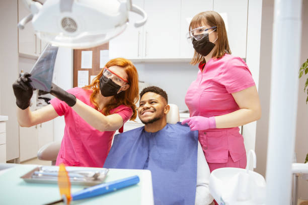 istock Young African-American man at dental office 1320158329