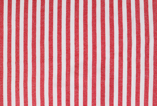 Istanbul, Turkey-May 24, 2021: Red and white striped beach towel. Towel has vertical stripes. Shot with Canon EOS R5. Full frame, flat lay, sunlight.