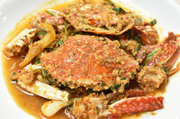istock stir fried swimmer crab in yellow curry and egg 1320158397