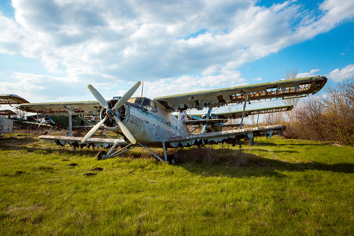 Old Soviet military aircraft standing at the airfield. Rusty used technique