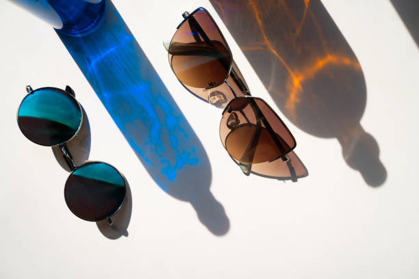 istock Blue and brown sunglasses with glass bottle reflections 1320161147