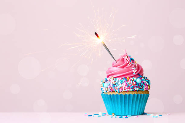 istock Birthday cupcake with celebration sparkler and colorful sprinkles 1320162910