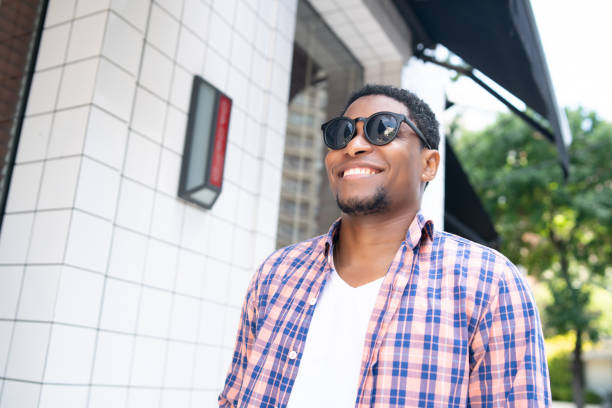 istock African american man smiling while walking outdoors. 1320163546
