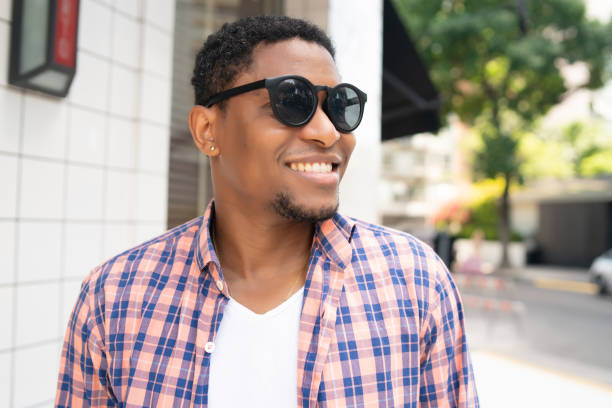 istock African american man smiling while walking outdoors. 1320163547
