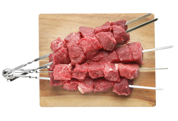 istock Metal skewers with raw meat on white background, top view 1320163822