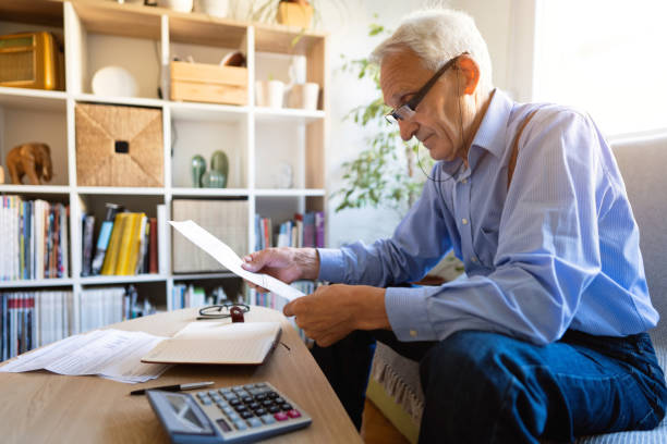 istock Senior man  planning his home budget 1320164082