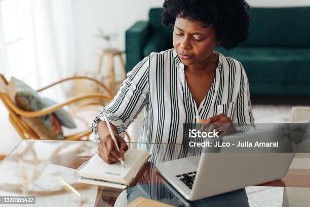 African Woman Working From Home Stock Photo - Download Image Now - Senior Adult, Writing - Activity, Laptop