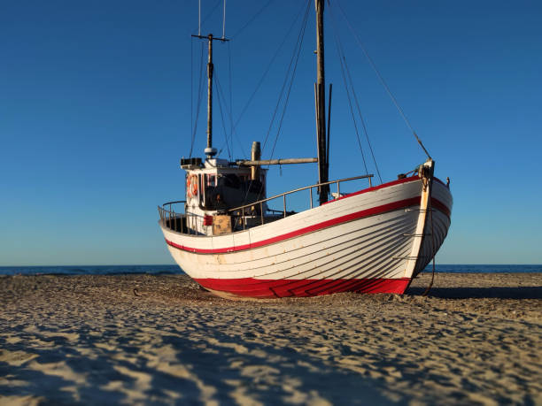 istock fishing boat on the beach 1320166624