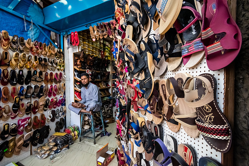 Bangalore, Karnataka, India - January 2019: A shoe store with a variety of fashionable slippers and footwear on display on a market street in the city of Bengaluru.