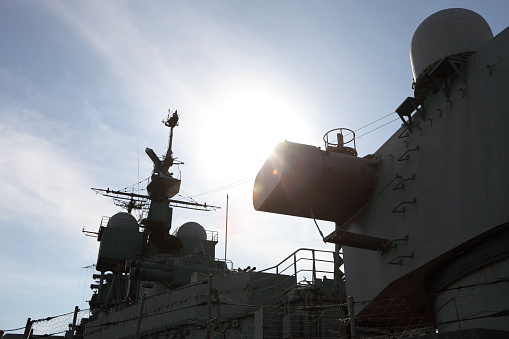 Navy frigate moored at naval dockyard.