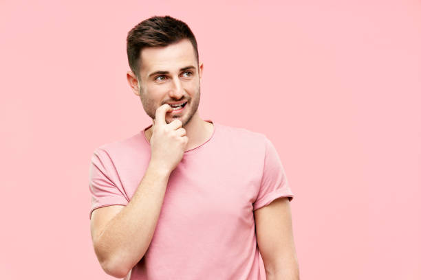 istock Funny pensive man have doubts making decision looking to copy space on pink background 1320168164