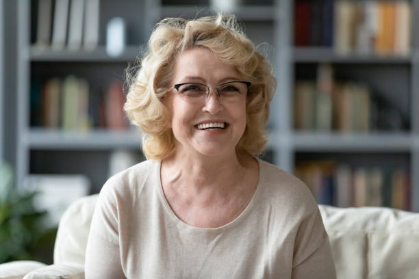 istock Happy older 60s woman enjoying video call conversation. 1320169760